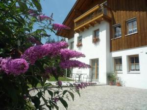a building with purple flowers in front of it at Haus Margreitter in Wald am Arlberg