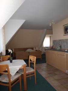 a kitchen and dining room with a table and chairs at Hotel Societät in Emmerich