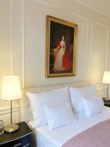 a bedroom with a bed with a portrait of a woman at Imperium Residence - Experience the most Luxurious Apartment in Vienna Center in Vienna