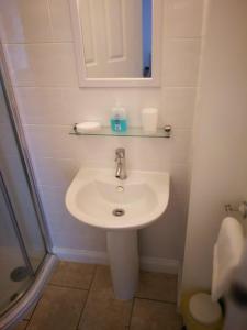 a bathroom with a sink and a mirror and a shower at Delamere Hotel in Blackpool