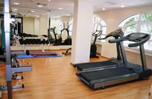 a gym with a treadmill and other exercise equipment at Crithoni's Paradise Hotel in Alinda