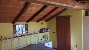 a bedroom with a bed and a wooden ceiling at La Palma in Bari Sardo