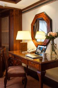 a wooden table with a mirror and a lamp at Hotel Plaza San Francisco in Santiago