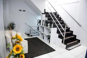 a staircase in a house with sunflowers at Bellonorte Hotel in Altamira
