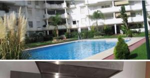 a large swimming pool in front of a building at Carihuela Beach Pool Garage Wifi in Torremolinos