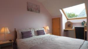 a bedroom with a large bed with a window at Stonehaven B&B in Ennis