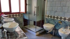 a bathroom with a shower and a toilet and a sink at La Palma in Bari Sardo