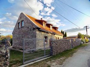 an old stone house with an orange roof at Smithy Rustic House in Balatonfüred
