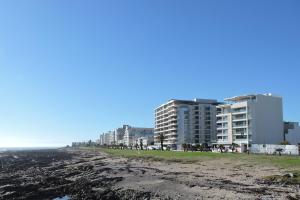 a view of the beach and buildings at Sandringham in Cape Town