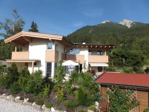 a house with a mountain in the background at Krinzerhäusl in Seefeld in Tirol