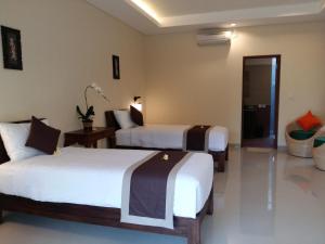 Ein Bett oder Betten in einem Zimmer der Unterkunft Darra Ria Villa Ubud
