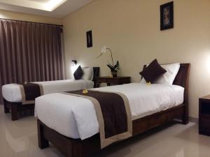 Ein Bett oder Betten in einem Zimmer der Unterkunft Darra Ria Villa Ubud