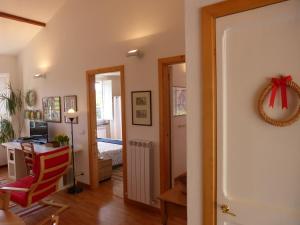 a living room with a red chair and a desk at Garden Lodge in Chiavari