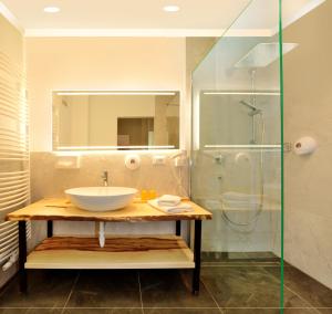 a bathroom with a sink and a shower at Hotel Flötscherhof in Naz-Sciaves +44 photos