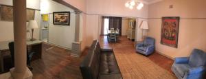 a living room with a couch and two chairs at Villa Brocant Guest house in Vryburg