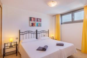 a bedroom with a bed with two towels on it at Hotel LIVVO Corralejo Beach in Corralejo