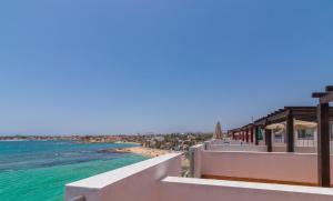 a view of the beach from the balcony of a resort at Hotel LIVVO Corralejo Beach in Corralejo