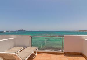 a balcony with a view of the ocean at Hotel LIVVO Corralejo Beach in Corralejo