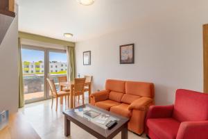 a living room with a couch and a table at Hotel LIVVO Corralejo Beach in Corralejo