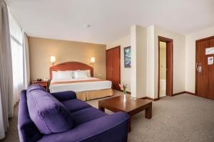 Postel nebo postele na pokoji v ubytování Hotel Quito