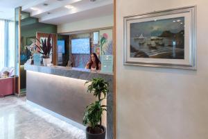 a woman sitting at the counter of a restaurant at Hotel Soraya in San Benedetto del Tronto +63 photos