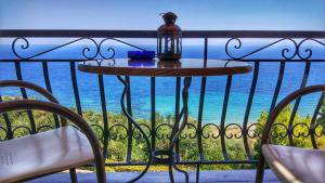 a table on a balcony with a view of the ocean at Villa Contessa in Vasilikos