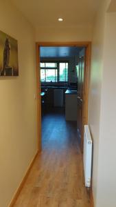 an empty room with a hallway leading to a kitchen at Countryside Lodge in Peterborough +3 photos