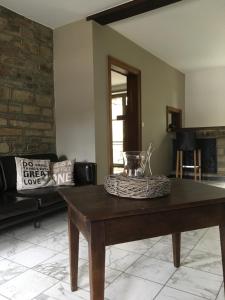 a living room with a table and a couch at Le gîte de la vieille église in Tenneville