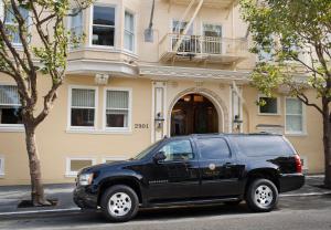 a black suv parked in front of a building at Hotel Drisco in San Francisco