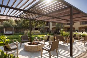 a patio with a wooden pergola and a fire pit at Napa Valley Lodge in Yountville