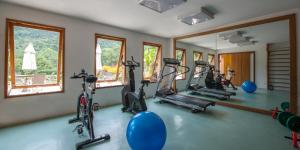 a gym with bikes and exercise equipment in a room at Parador Lumiar in Lumiar