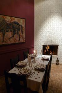 a dining room with a table and a fireplace at La Fontaine Bleue in Essaouira