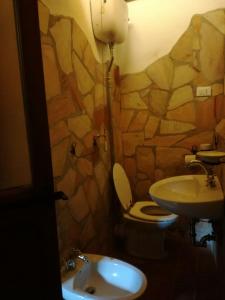 a bathroom with a toilet and a sink at Casamatta a Blera in Blera
