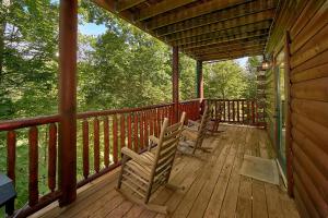 two rocking chairs on a porch of a cabin at Natural Attractions in Gatlinburg