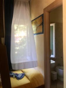 a bedroom with a window and a bed and a sink at Bed & Breakfast Bounty in Rio nellʼElba