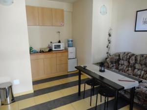 a living room with a couch and a table at Avel Guest House in Sofia