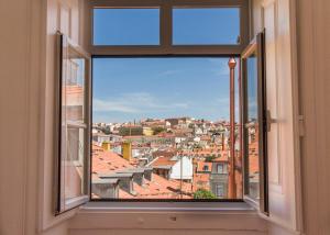 a window with a view of a city at City Lofts Lisbon - Guesthouse in Lisbon