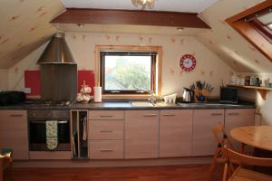 a kitchen with a sink and a window in a room at Tamara Apartment in Sandwick