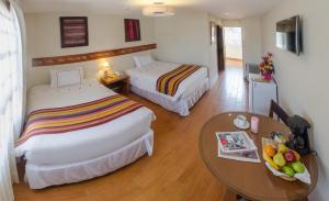 Postel nebo postele na pokoji v ubytování Taypikala Hotel Cusco