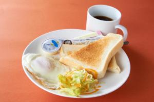 a plate of eggs and toast with a cup of coffee at Hotel Carnival (Love Hotel) in Miyaki