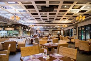 a dining room with tables and chairs in a restaurant at Le Grande Bali in Uluwatu