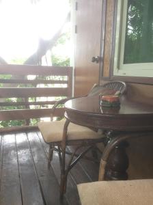 a wooden table and chairs on a porch at Mountain View GuesthouseChiangmai in Chiang Mai