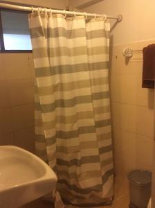 a bathroom with a shower curtain and a sink at Mountain View GuesthouseChiangmai in Chiang Mai