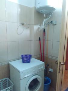 a small bathroom with a washing machine in it at The Green Apartment in Golem