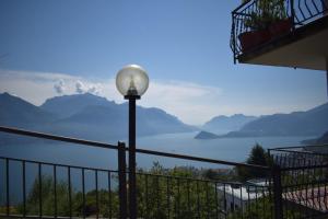 a street light with a view of the water and mountains at Landscapesilvia Acqua in Menaggio