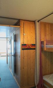 a room with wooden walls and ajar doors at PIERRA MENTA ARC 1800 Studio Appartement - 5 per in Arc 1800