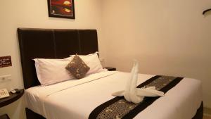 Postel nebo postele na pokoji v ubytování Sunrise Hotel Jombor Jogja