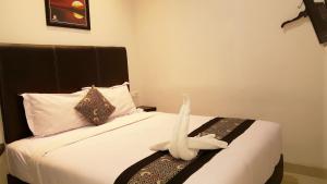 Postel nebo postele na pokoji v ubytování Sunrise Hotel Jombor Jogja