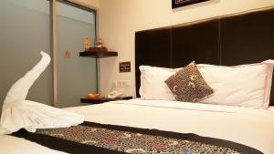 Postel nebo postele na pokoji v ubytování Sunrise Hotel Jombor Jogja