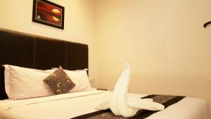 Postel nebo postele na pokoji v ubytování Sunrise Hotel Jombor Jogja